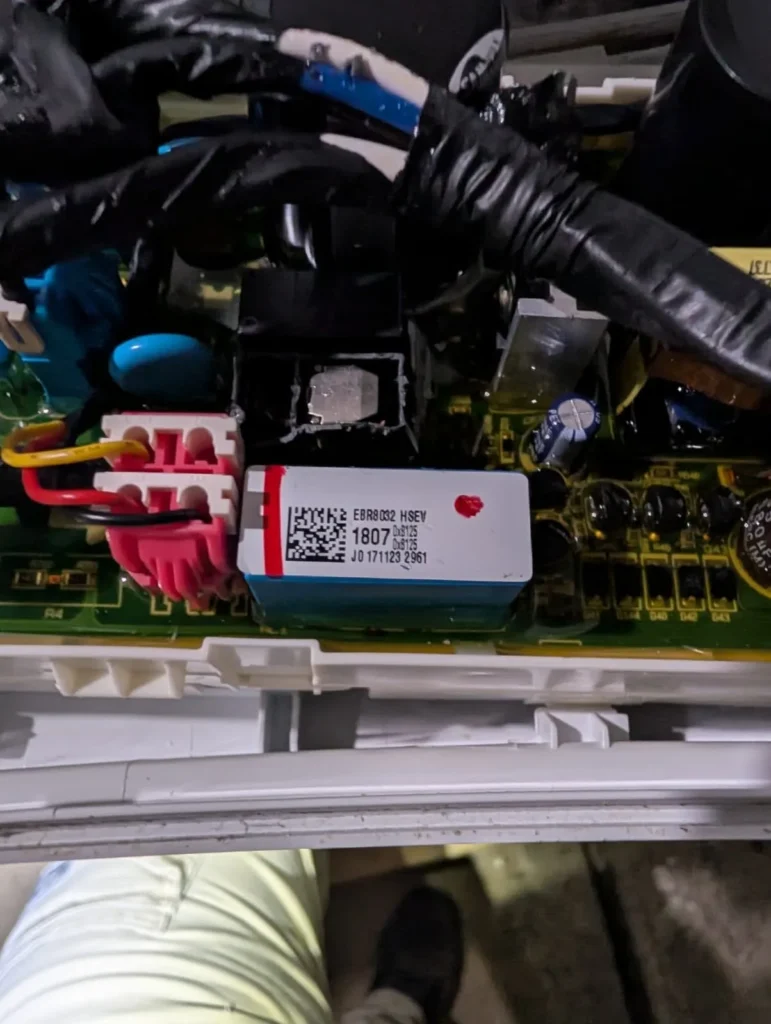 Close-up of a refrigerator electronic control board and wiring.