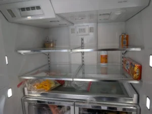 Refrigerator interior and shelves inspected during cooling service.