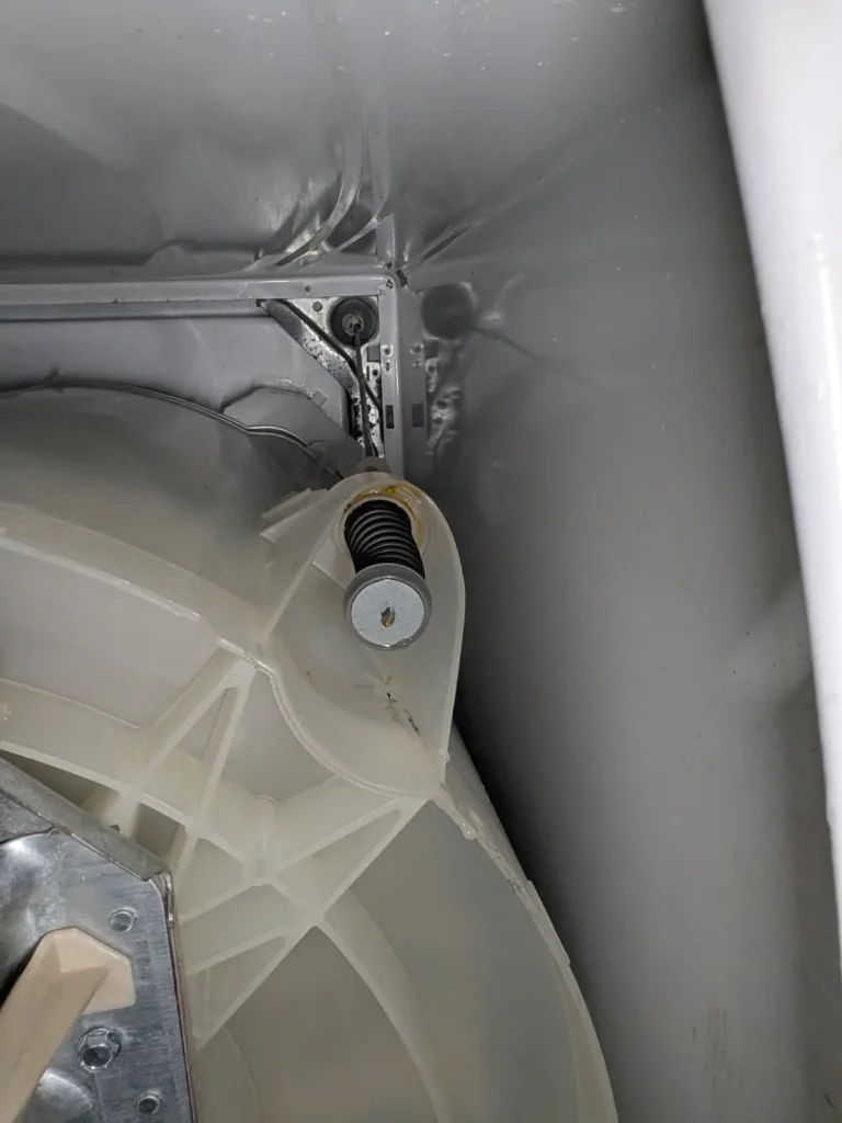 Internal top-load washer tub component exposed for repair.