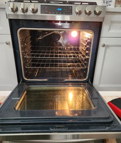 Samsung oven open with the interior light on during a heating test.