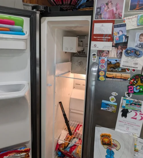 Side-by-side refrigerator open during a home service visit.
